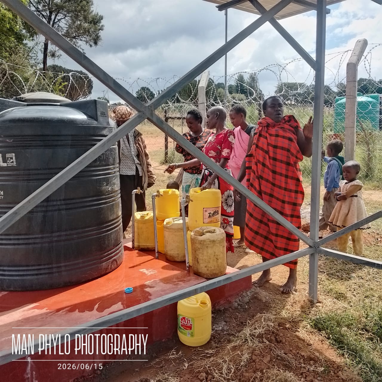 Community at Chumvi water point with elder and children